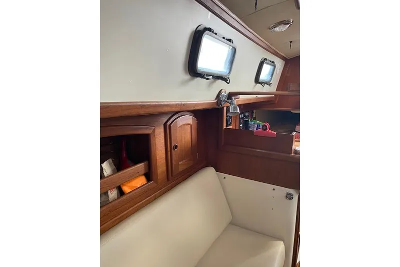 Slide: The Image of Interior of 1995 Pacific Seacraft Crealock 34 sailboat with wooden cabinetry and seating. - 22