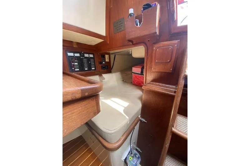 Slide: The Image of Interior of 1995 Pacific Seacraft Crealock 34 sailboat with wooden cabinetry and control panel. - 26