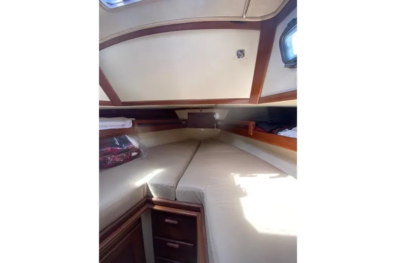 Slide: The Image of Interior cabin of 1995 Pacific Seacraft Crealock 34 sailboat, featuring cozy sleeping area. - 29