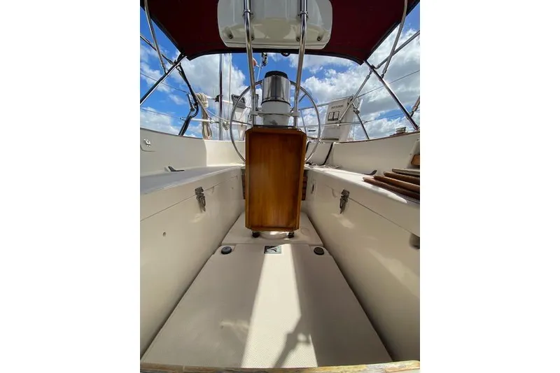 Slide: The Image of Cockpit of 1995 Pacific Seacraft Crealock 34 sailboat with wooden accents and canopy. - 32