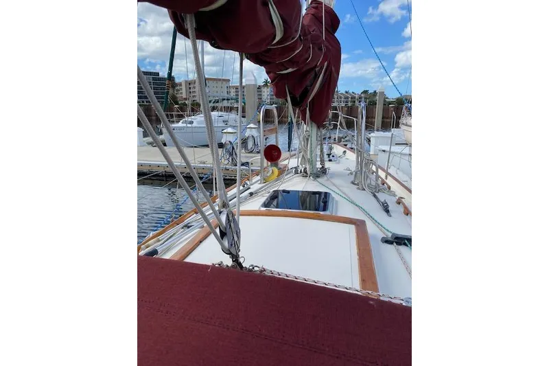 Slide: The Image of Sailboat deck view of 1995 Pacific Seacraft Crealock 34 at marina, clear sky. - 36