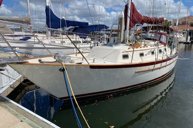Slide: The Image of Sailboat docked in marina, 1995 Pacific Seacraft Crealock 34, clear skies above. - 39