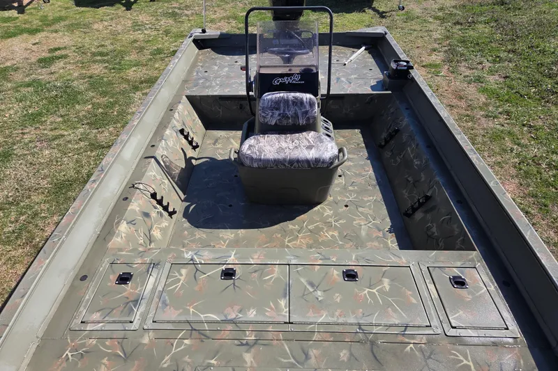 Slide: The Image of 2022 Tracker Grizzly 2072 CC boat with camo interior, center console, and seating. - 11