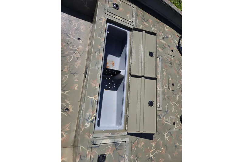 Slide: The Image of 2022 Tracker Grizzly 2072 CC boat with camo pattern and open storage compartment. - 12
