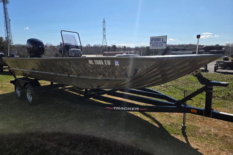 Slide: The Image of 2022 Tracker Grizzly 2072 CC boat on trailer, parked outdoors under clear sky. - 3