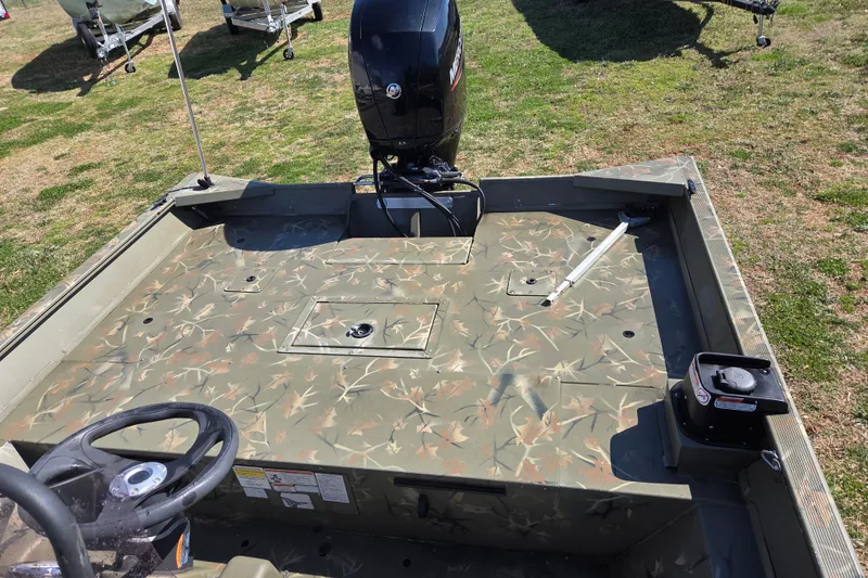 Slide: The Image of 2022 Tracker Grizzly 2072 CC boat with camouflage deck and outboard motor. - 9