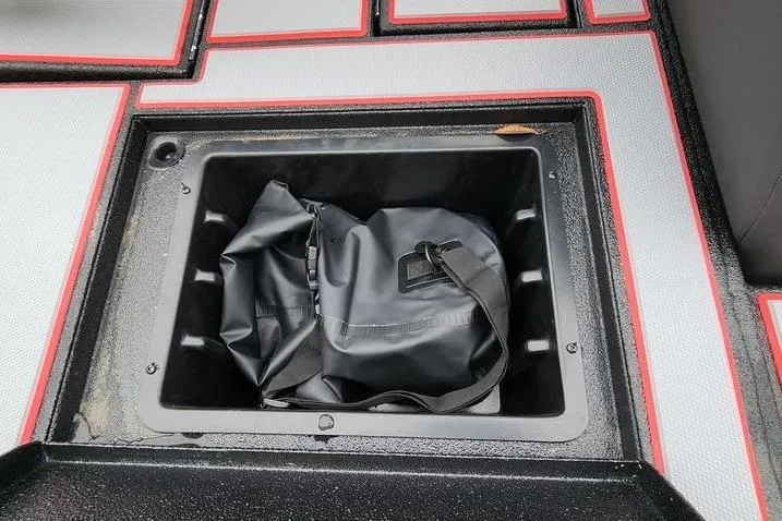 Slide: The Image of Storage compartment in 2025 Xpress H20 Bass boat with a black bag inside. - 10