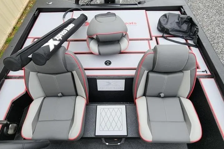 Slide: The Image of 2025 Xpress H20 Bass boat interior with gray and red seating, storage compartments. - 16