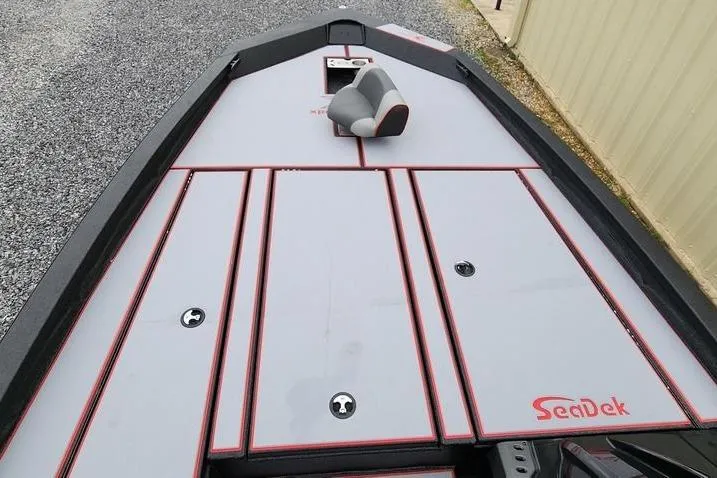 Slide: The Image of 2025 Xpress H20 Bass boat deck with SeaDek flooring, gray and red design. - 18