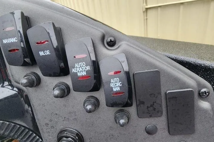 Slide: The Image of Control panel of 2025 Xpress H20 Bass boat with various switches. - 3