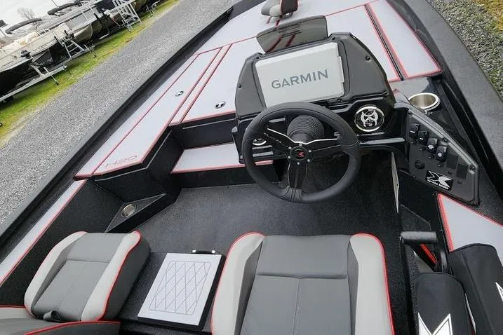 Slide: The Image of 2025 Xpress H20 Bass boat interior with Garmin navigation system and modern seating. - 6