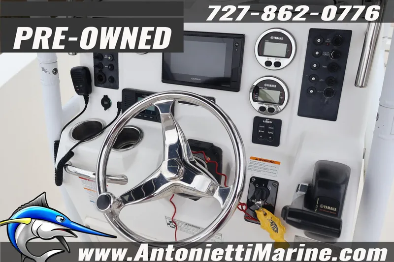Slide: The Image of Pre-owned 2017 Robalo R200 Center Console boat dashboard with steering wheel and controls. - 11