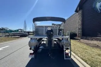 Slide: The Image of 2021 Sun Tracker Party Barge 20 DLX pontoon boat, rear view, parked outdoors. - 4