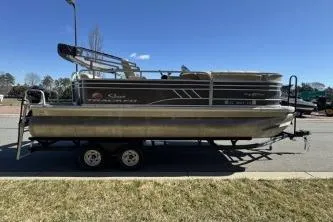 Slide: The Image of 2021 Sun Tracker Party Barge 20 DLX pontoon boat on trailer, parked outdoors. - 5