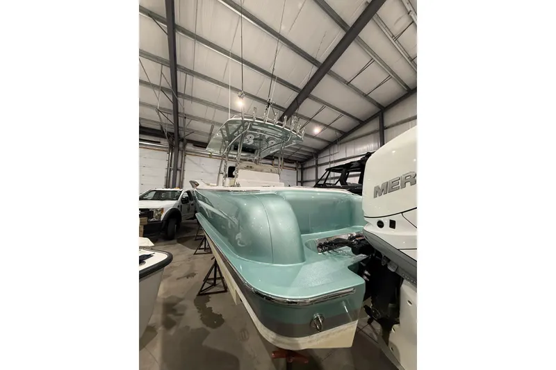 Slide: The Image of 2021 Mag Bay 33 CC boat in a storage facility, featuring sleek design and modern equipment. - 11