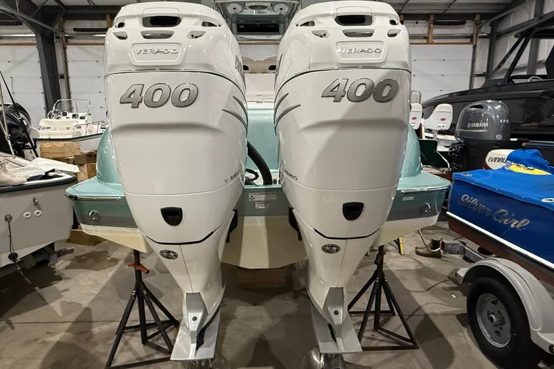 Slide: The Image of 2021 Mag Bay 33 CC boat in a storage facility, showcasing sleek design and mint green hull. - 17