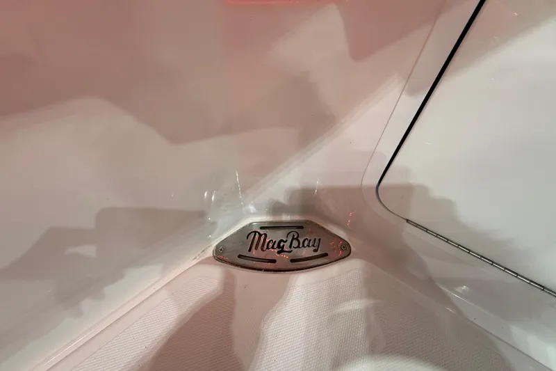 Slide: The Image of 2021 Mag Bay 33 CC boat with Mercury engine in a storage facility. - 21