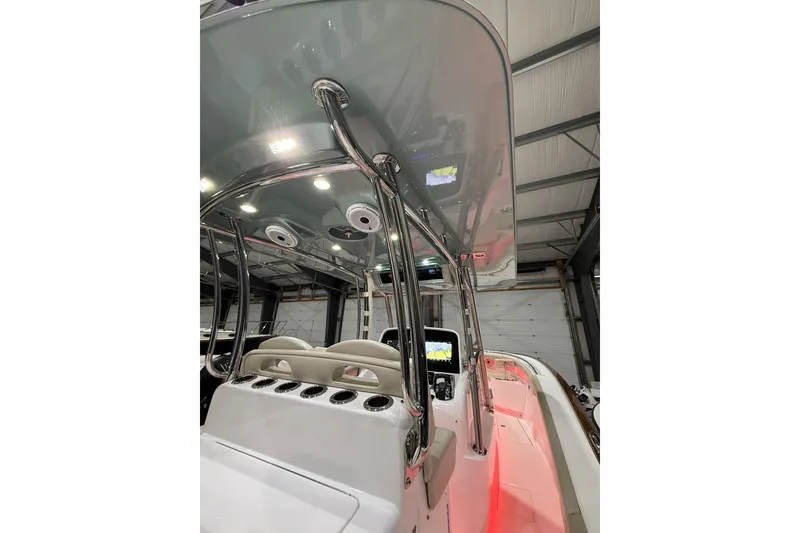 Slide: The Image of 2021 Mag Bay 33 CC with twin 400 Verado engines in a boat storage facility. - 25