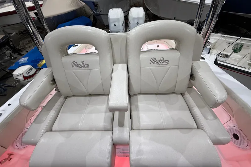 Slide: The Image of Open storage compartment on 2021 Mag Bay 33 CC boat, featuring a white interior. - 30