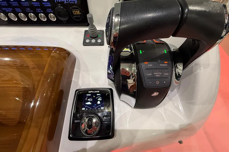 Slide: The Image of 2021 Mag Bay 33 CC boat interior with cushioned seating and storage compartment. - 35