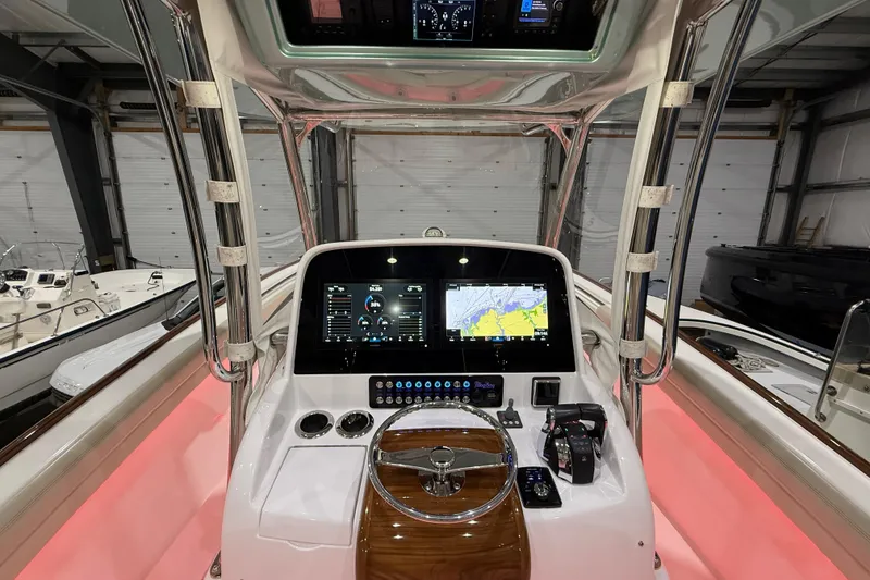 Slide: The Image of Interior view of a 2021 Mag Bay 33 CC in a boat storage facility. - 37