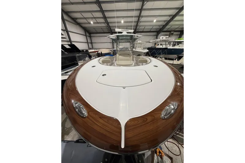 Slide: The Image of 2021 Mag Bay 33 CC boat docked at marina, calm water, clear sky. - 4