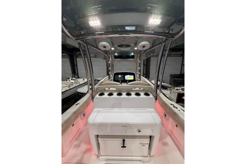 Slide: The Image of Control panel of 2021 Mag Bay 33 CC boat with illuminated switches and brand logo. - 45