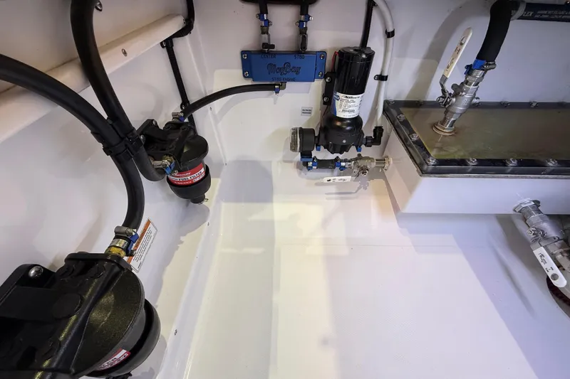 Slide: The Image of 2021 Mag Bay 33 CC boat interior with sink and storage compartments. - 50