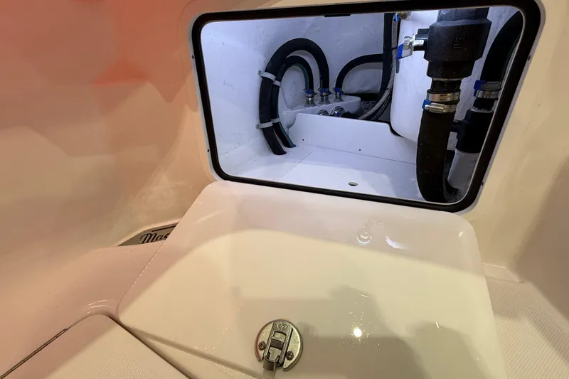 Slide: The Image of 2021 Mag Bay 33 CC boat interior with modern console and seating in a showroom. - 55