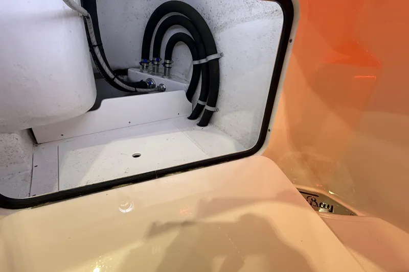 Slide: The Image of 2021 Mag Bay 33 CC boat console with rod holders and storage compartment. - 56