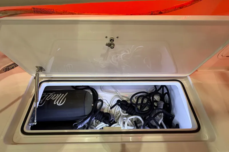 Slide: The Image of Engine compartment of 2021 Mag Bay 33 CC boat, showcasing hoses and components. - 58