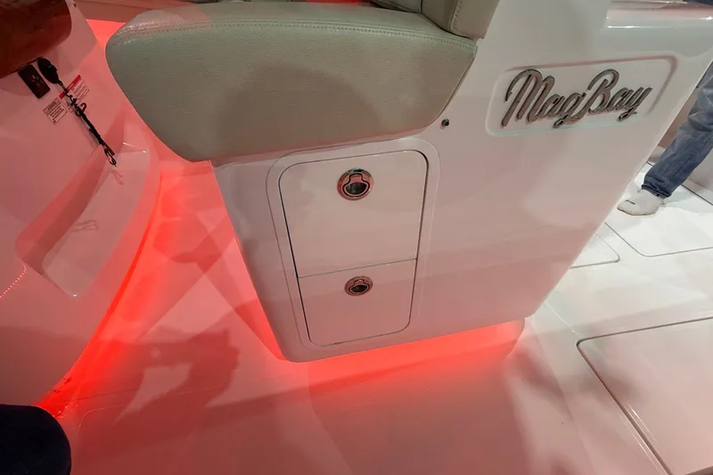 Slide: The Image of Open hatch on 2021 Mag Bay 33 CC boat, revealing interior compartment. - 61