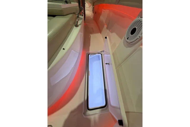Slide: The Image of 2021 Mag Bay 33 CC boat storage compartment with red ambient lighting. - 69