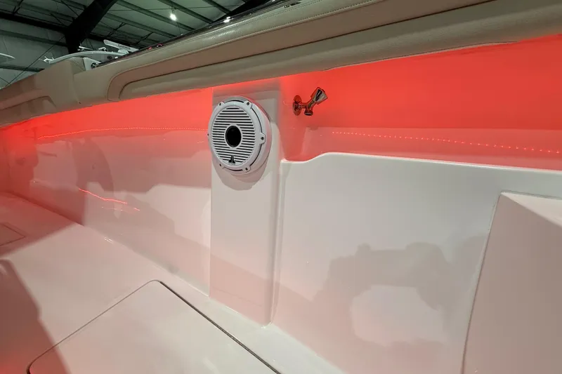 Slide: The Image of 2021 Mag Bay 33 CC boat interior with red LED lighting and storage compartments. - 70