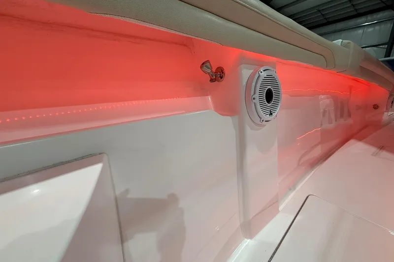 Slide: The Image of 2021 Mag Bay 33 CC boat interior with red LED lighting and storage compartments. - 71