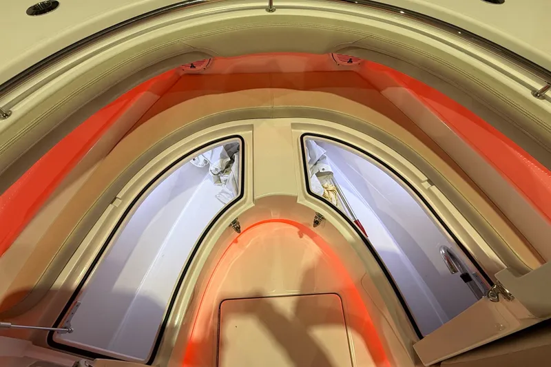 Slide: The Image of Close-up of 2021 Mag Bay 33 CC's polished metal detail in a boat showroom. - 76