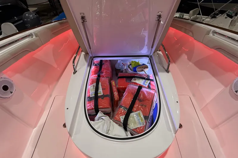 Slide: The Image of 2021 Mag Bay 33 CC boat interior with red LED lighting and speaker detail. - 79