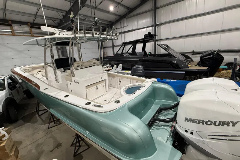 Slide: The Image of 2021 Mag Bay 33 CC boat with vibrant red interior lighting at a marina. - 8