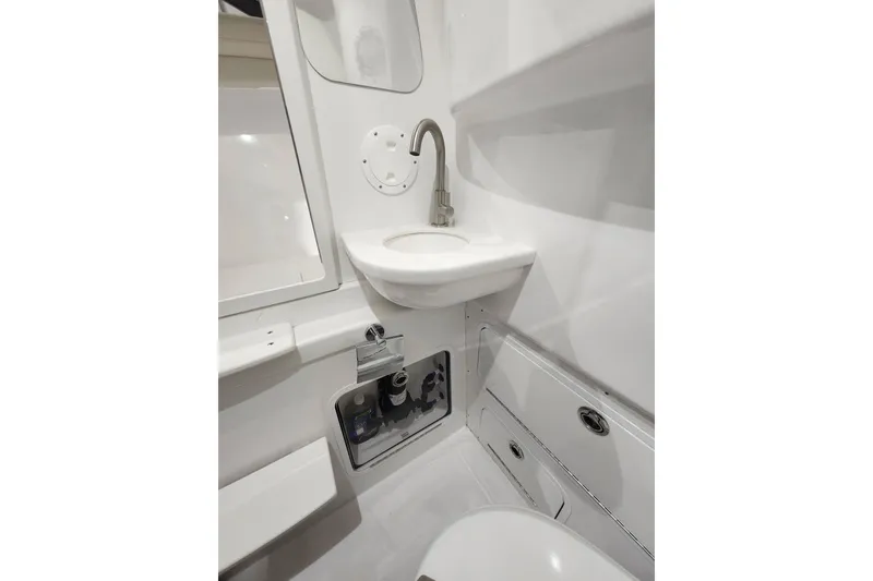 Slide: The Image of 2021 Mag Bay 33 CC boat interior with sink and storage compartments. - 94