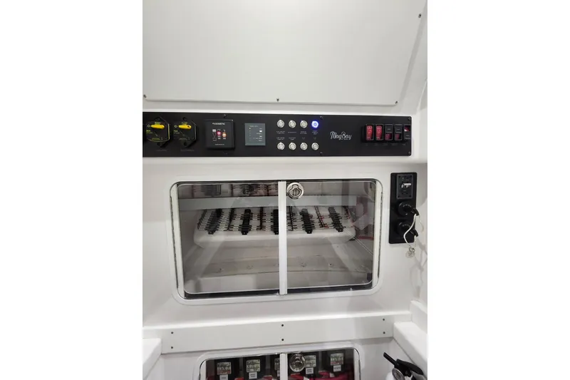Slide: The Image of Control panel of 2021 Mag Bay 33 CC boat, featuring switches and gauges. - 95