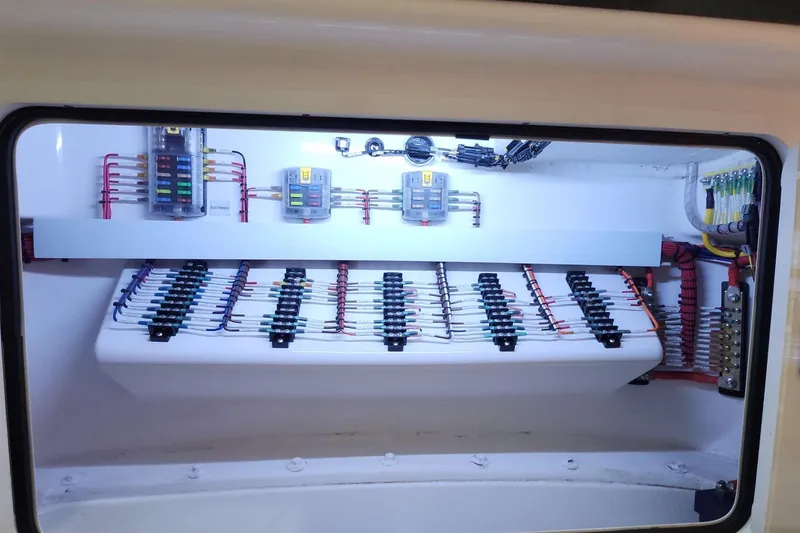 Slide: The Image of Electrical panel of 2021 Mag Bay 33 CC boat, showcasing organized wiring and components. - 97