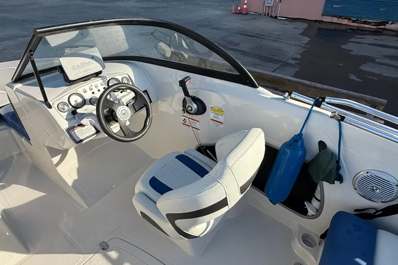 Slide: The Image of 2016 Tahoe 450 TS boat interior with steering wheel and dashboard controls. - 12