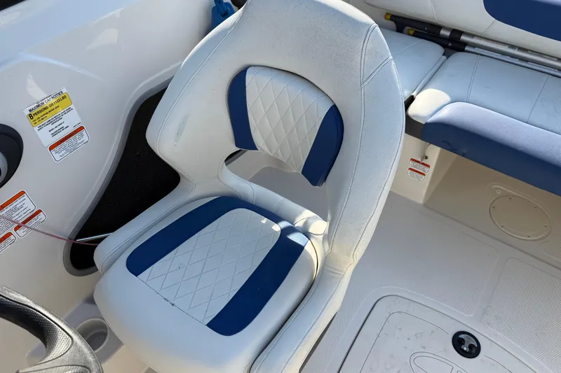 Slide: The Image of White and blue seating in a 2016 Tahoe 450 TS boat interior. - 15