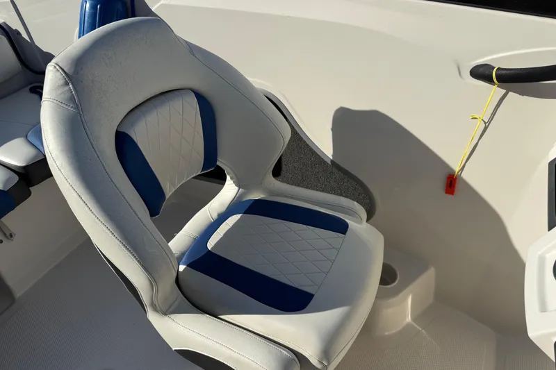 Slide: The Image of Boat seat in a 2016 Tahoe 450 TS, featuring blue and white upholstery. - 18