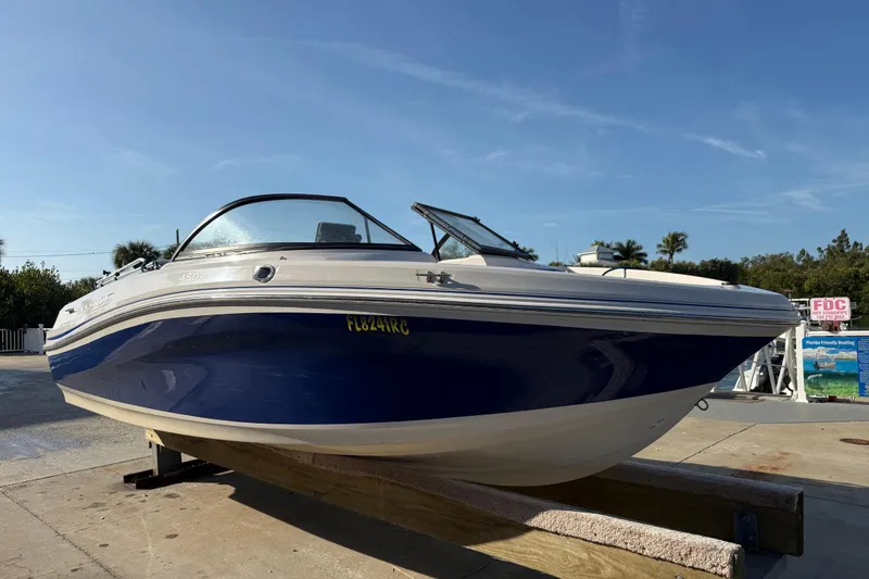 Slide: The Image of 2016 Tahoe 450 TS boat on display, blue and white design, sunny day background. - 3