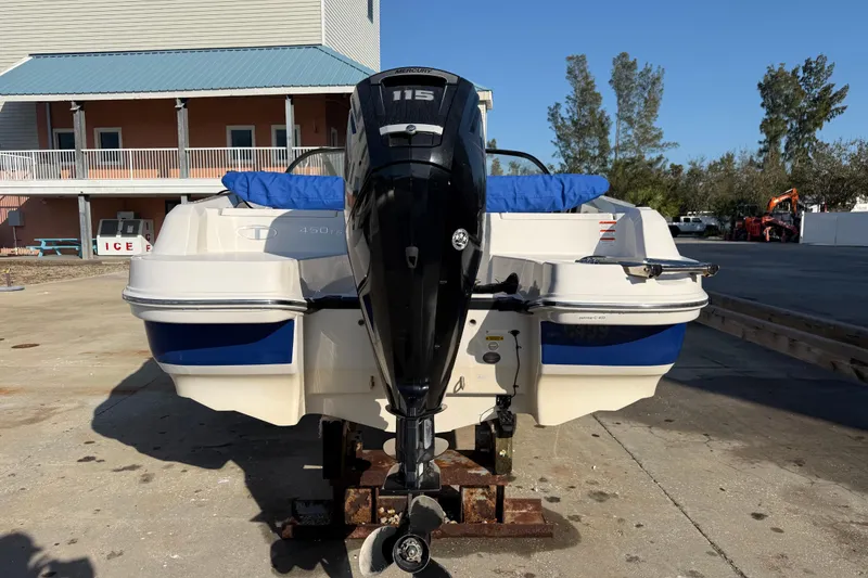 Slide: The Image of 2016 Tahoe 450 TS boat with Mercury 115 outboard motor, docked on a sunny day. - 5