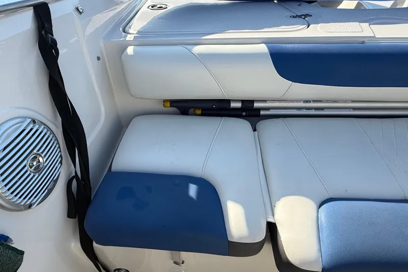 Slide: The Image of Interior of a 2016 Tahoe 450 TS boat with blue and white seating. - 9