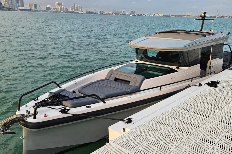 Slide: The Image of 2021 Axopar 37 XC Cross Cabin boat docked on calm water. - 3