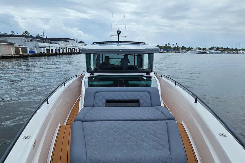 Slide: The Image of 2021 Axopar 37 XC Cross Cabin boat on calm waters, featuring luxurious seating. - 5