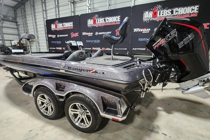 Slide: The Image of 2024 Ranger Z519 boat with dual axle trailer and powerful engine in showroom. - 3